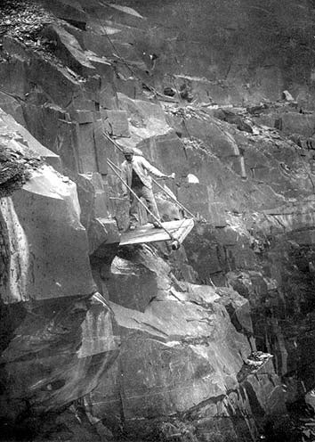 Photograph: Drilling by hand on a platform at Penrhyn Quarry, Bethesda.