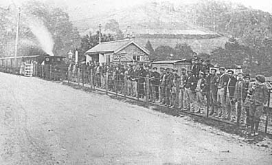 Photograph: Quarrymen waiting at Llwyngwern Station to catch the train home. [David Coleman].