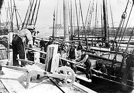 Photograph: View of schooner being loaded with slates at Greaves' Wharf, Porthmadog.
