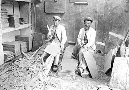 Photograph: Splitting and dressing slates with the hand knife, Dorothea Quarry, Nantlle.