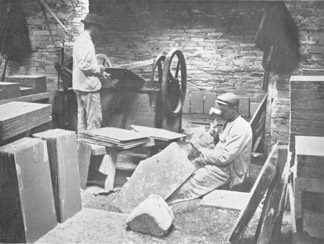 A quarryman splitting slates