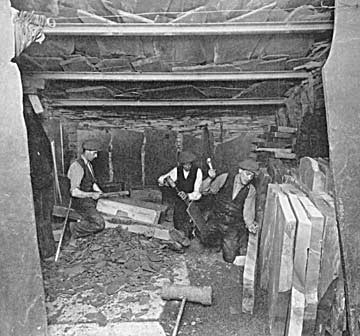 Quarrymen splitting and dressing slate blocks